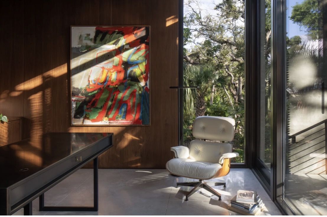 Abstract painting in a sunlit Sarasota-area study with walnut paneling